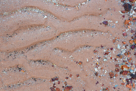 Red sand of natural origin on the seashore on Koh Samui in Thailand, terracotta color