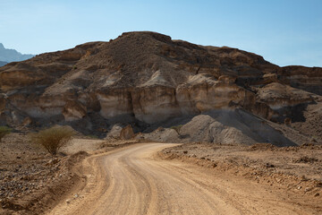 Gravel road and mountain landscape in Oman