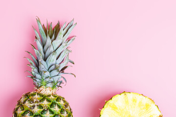 Fresh ripe pineapple and sliced pineapple on a pink background. summer concept. copy space, minimalism, flat lay, top view.