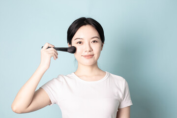 A Young Chinese Woman In Front of Blue Background