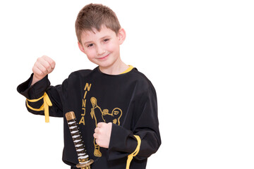 Boy age 8 fighting like karate player - black ninja.