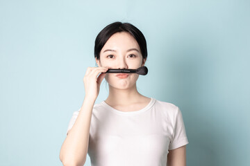 A Young Chinese Woman In Front of Blue Background