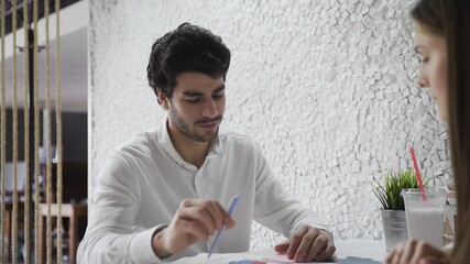 Two Economic Analytics Work, They Discuss Statistics, Graphs and Data