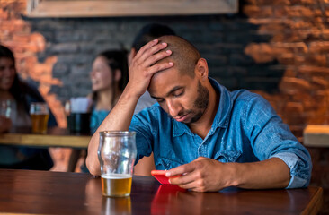 A lonely man sitting at the bar