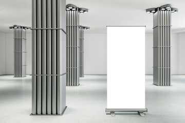 Minimalistic gallery interior with silver pipe columns and blank vertical poster.
