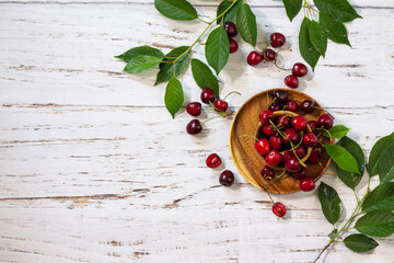 Ripe juicy berry cherry in a bowl on a kitchen rustic table. Top view flat lay background. Copy space.