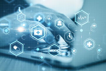 Close up of businessman hand using laptop with medical hologram.