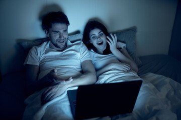 Cheerful young couple sleeping on bed