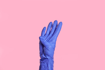 The number four. An isolated female in a medical glove shows a figure. Isolated