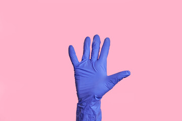 The number five. An isolated female in a medical glove shows a figure. Isolated