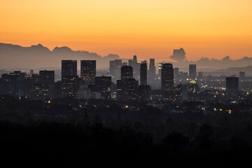 Sunset dusk view of Century City and downtown Los Angeles towers in Southern California.