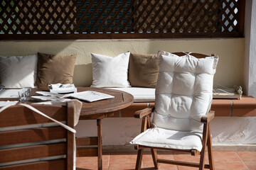 Wooden table and comfortable chairs on a porch