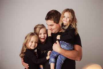 happy dad with three daughters waiting for baby