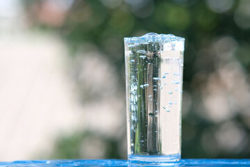 Glasses of water on a wooden table background and space for text