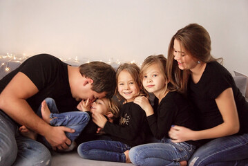 happy family with three daughters waiting for the baby