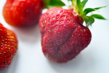 Red juicy strawberries on a light table