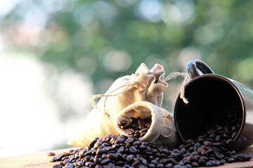 close up coffee beans and coffee cup on wood table background and space