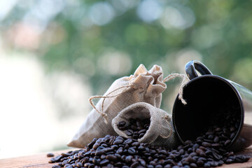 close up coffee beans and coffee cup on wood table background and space
