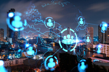 Obraz na płótnie Canvas Glowing Social media icons on night panoramic city view of Bangkok, Asia. The concept of networking and establishing new connections between people and businesses. Double exposure.