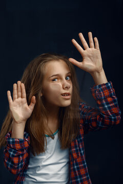 Little Girl Makes Face Leaning Against The Glass