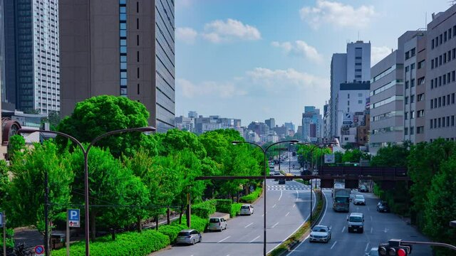 A timelapse of city street at Yasukuni avenue in Tokyo daytime wide shot panning