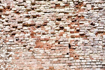 Old Brick wall surface close up. Bricks wall Texture. Loft interior and exterior design. Bricks in the wall. Brickwork close up view. Natural vintage stone walls pattern. Antique stonework Texture.