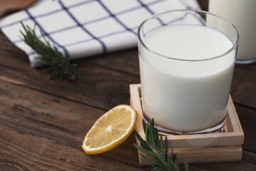 milk in glass on wood food background