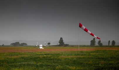 Windsock, weather vane for airfields. Red and white striped fabric showing wind speed, strength and...