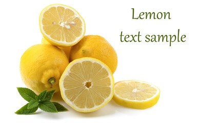 lemons whole and sliced, mint leaves, close-up on a white background, text space, horizontal view