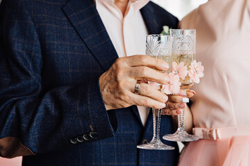 bride and groom holding champagne glasses