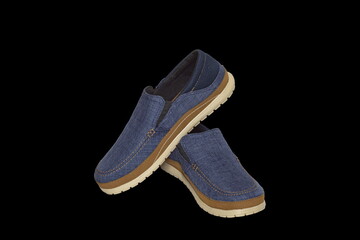 Blue slip-on casual male shoes with brown welt and beige sole over black background. Isolated. Use for catalogues, online shops, web sites, advertising booklet, poster. Side wiew.