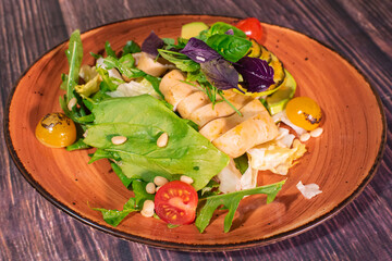 Tasty salad with grilled squid and avocado