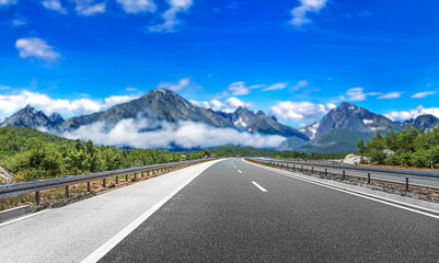 Mountain highway with blue sky and rocky mountains on a background