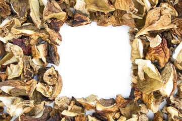 Background of dried mushrooms on a white surface. Porcini mushrooms, aspen, boletus. Photo background, texture with copy space.