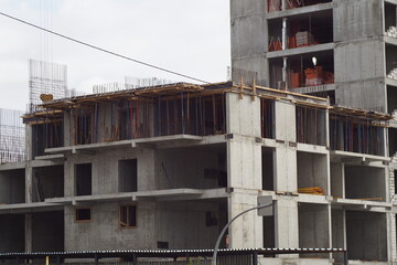 Concrete floors and walls made of foam concrete blocks of a residential building under construction. Bottom up view