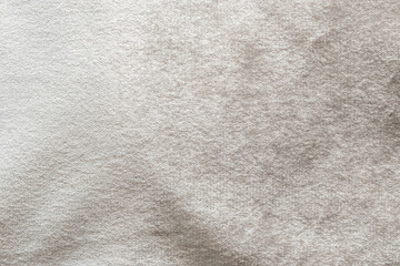 Beige velvet background or velour flannel texture made of cotton or wool with soft fluffy velvety...