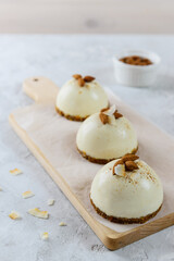 Raw cakes with almonds and coconut on a wooden board. Raw food dessert, vegetarian, vegan.