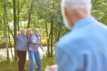 Gruppe Senioren beim Frisbee spielen im Park