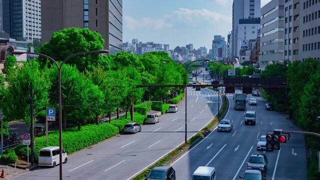 A timelapse of city street at Yasukuni avenue in Tokyo daytime wide shot zoom