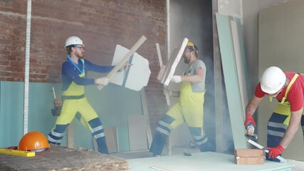 Builder fighting with construction tools and materials on work site