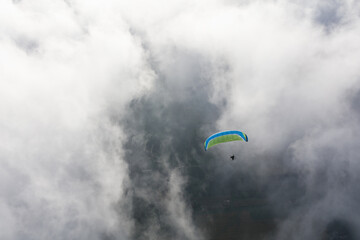 Paraglider above the clouds
