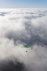 Paraglider above the clouds