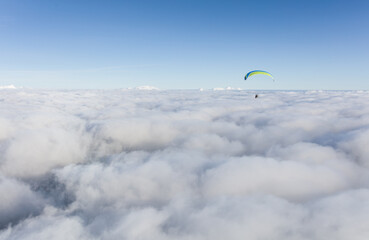 Paraglider above the clouds