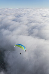 Paraglider above the clouds