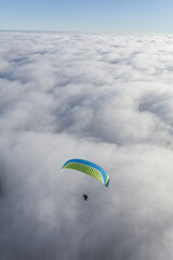 Paraglider above the clouds