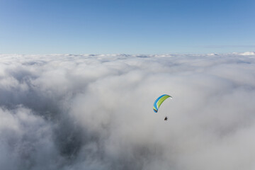 Paraglider above the clouds