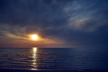 Sea sunset. Smoke wildfires sweeping across the sky.
