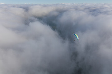 Paraglider above the clouds