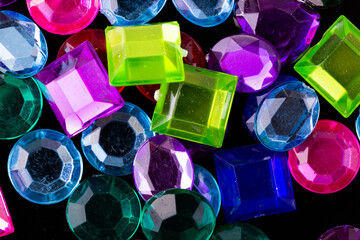 Fake gems jewels colorful on an isolated black background