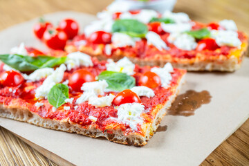 Pizza margarita with cherry tomato, basil and morzzarella cheese
